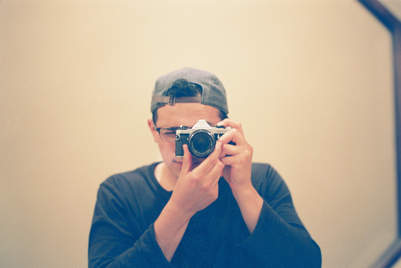 Allen closing his eyes with a friggin' jean jacket and a Pentax ME Super around his neck.